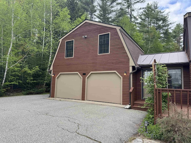 52 Jericho Rd, Grantham, NH 03753 - view of front of home featuring a garage, a standing seam roof, and metal roof