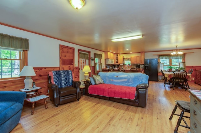 101 Mudgett Hill Rd, Loudon, NH 03307 - living room with a chandelier, light wood-style floors, wainscoting, healthy amount of natural light, and crown molding