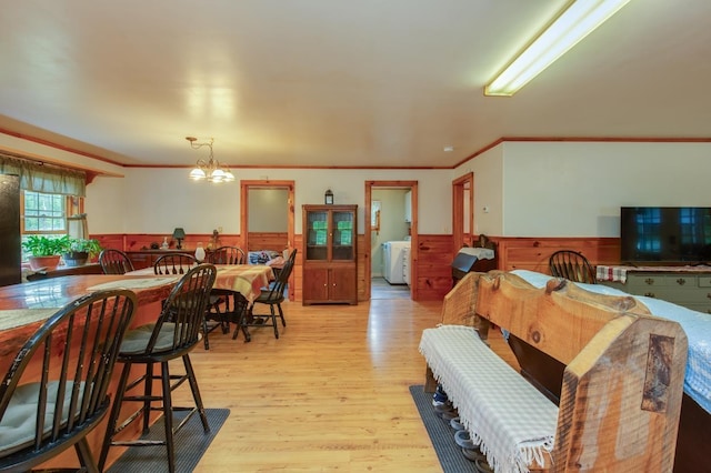 101 Mudgett Hill Rd, Loudon, NH 03307 - dining area featuring wainscoting, light wood finished floors, crown molding, a chandelier, and wooden walls