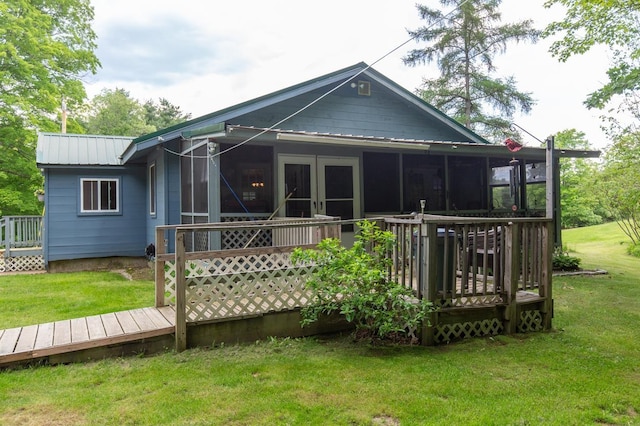 101 Mudgett Hill Rd, Loudon, NH 03307 - back of property featuring a deck, a sunroom, a lawn, and metal roof