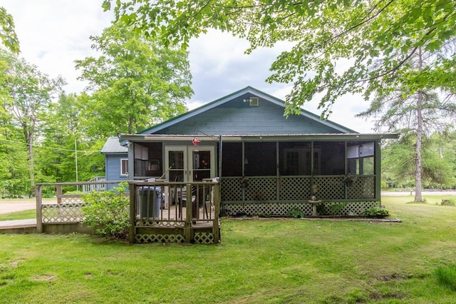 101 Mudgett Hill Rd, Loudon, NH 03307 - rear view of house featuring a sunroom, a lawn, and a wooden deck