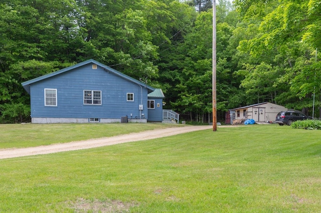 101 Mudgett Hill Rd, Loudon, NH 03307 - view of home's exterior with a lawn, dirt driveway, and central air condition unit