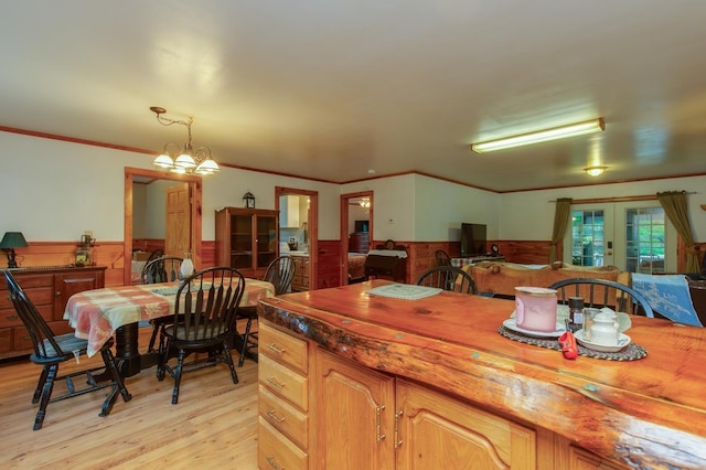 101 Mudgett Hill Rd, Loudon, NH 03307 - dining space featuring a wainscoted wall, french doors, light wood-style flooring, ornamental molding, and wooden walls
