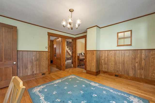 729 Suncook Valley Hwy, Epsom, NH 03234 - empty room with wainscoting, wood-type flooring, a chandelier, wooden walls, and crown molding