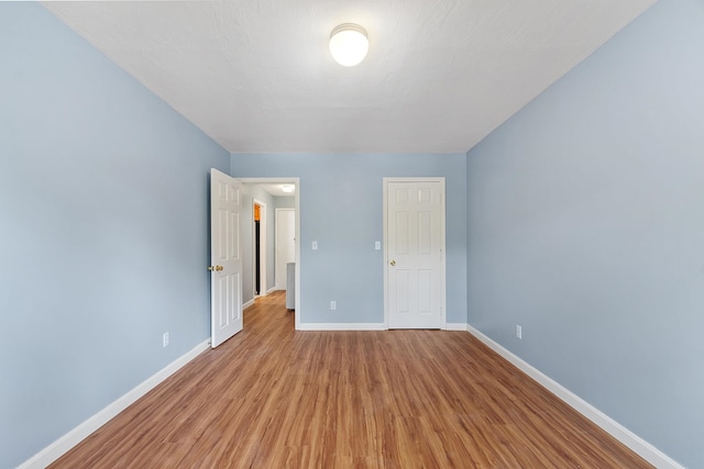 310 Brook Village Rd Unit 26, Nashua, NH 03062 - unfurnished bedroom with wood finished floors and baseboards