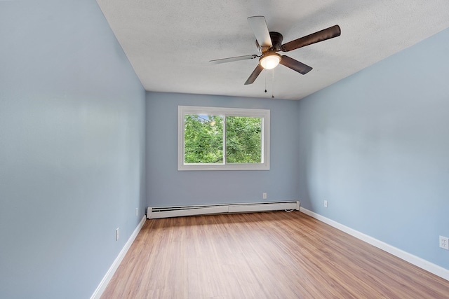 310 Brook Village Rd Unit 26, Nashua, NH 03062 - empty room featuring a baseboard radiator, wood finished floors, ceiling fan, baseboards, and a textured ceiling