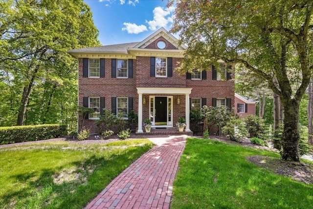 373 Whitford St, Manchester, NH 03104 - colonial inspired home featuring a front yard and brick siding