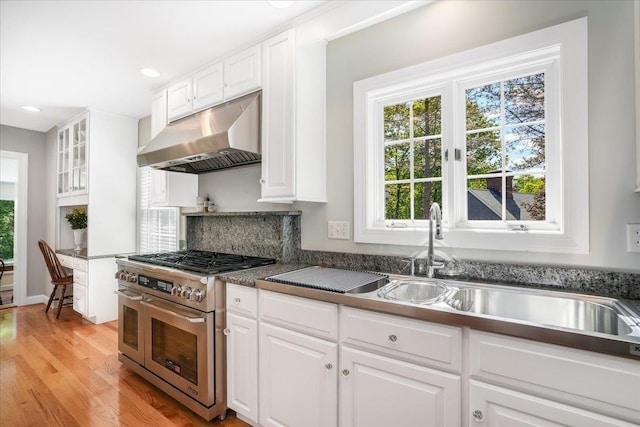 373 Whitford St, Manchester, NH 03104 - kitchen featuring range with two ovens, under cabinet range hood, white cabinetry, and recessed lighting