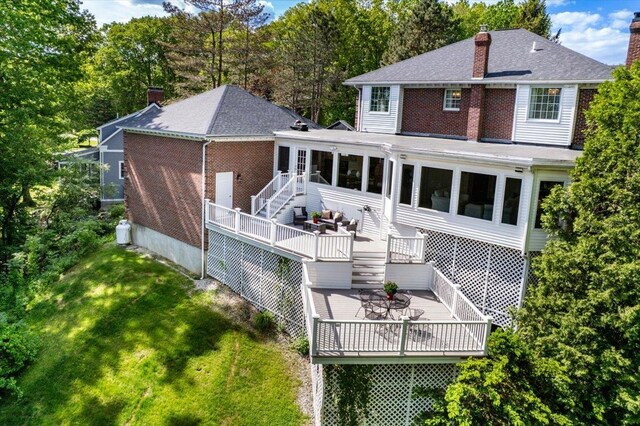 373 Whitford St, Manchester, NH 03104 - rear view of property featuring a sunroom, a chimney, stairs, and a shingled roof
