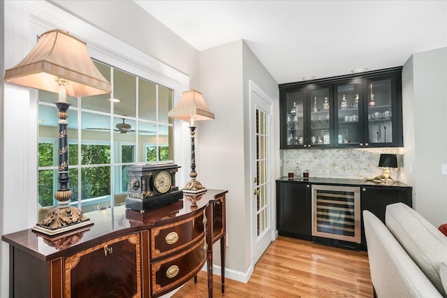 373 Whitford St, Manchester, NH 03104 - indoor dry bar with wine cooler, light wood-style floors, decorative backsplash, and ceiling fan