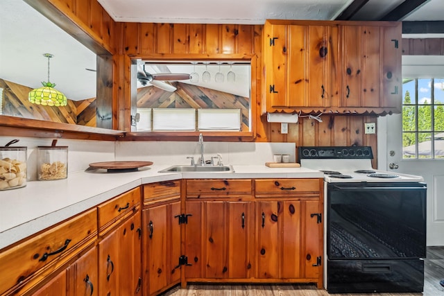 3-5 Cross St, Windham, NH 03087 - kitchen with electric range oven, a sink, light countertops, and brown cabinetry