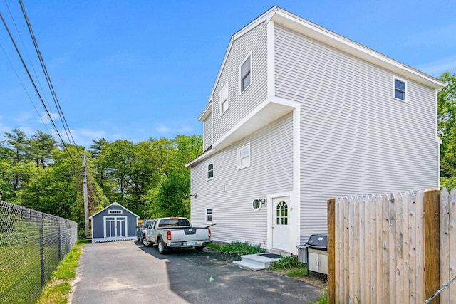 19 Fowlers Ct, Seabrook, NH 03874 - view of side of property with asphalt driveway