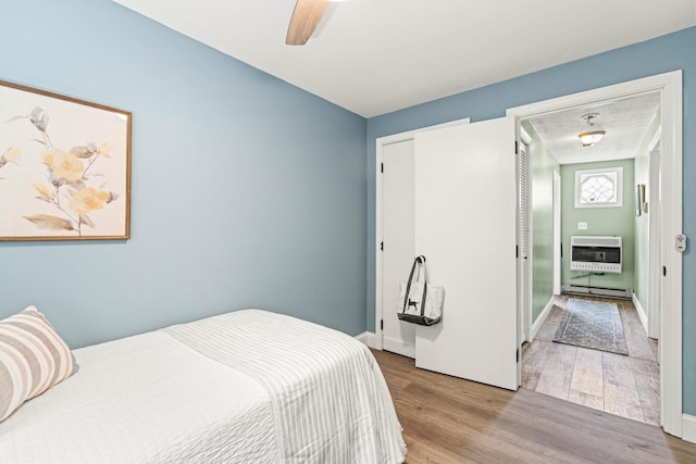 19 Fowlers Ct, Seabrook, NH 03874 - bedroom featuring heating unit, wood finished floors, a baseboard heating unit, ceiling fan, and a closet
