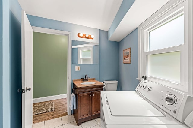 19 Fowlers Ct, Seabrook, NH 03874 - bathroom with washer / dryer, vanity, tile patterned floors, and toilet
