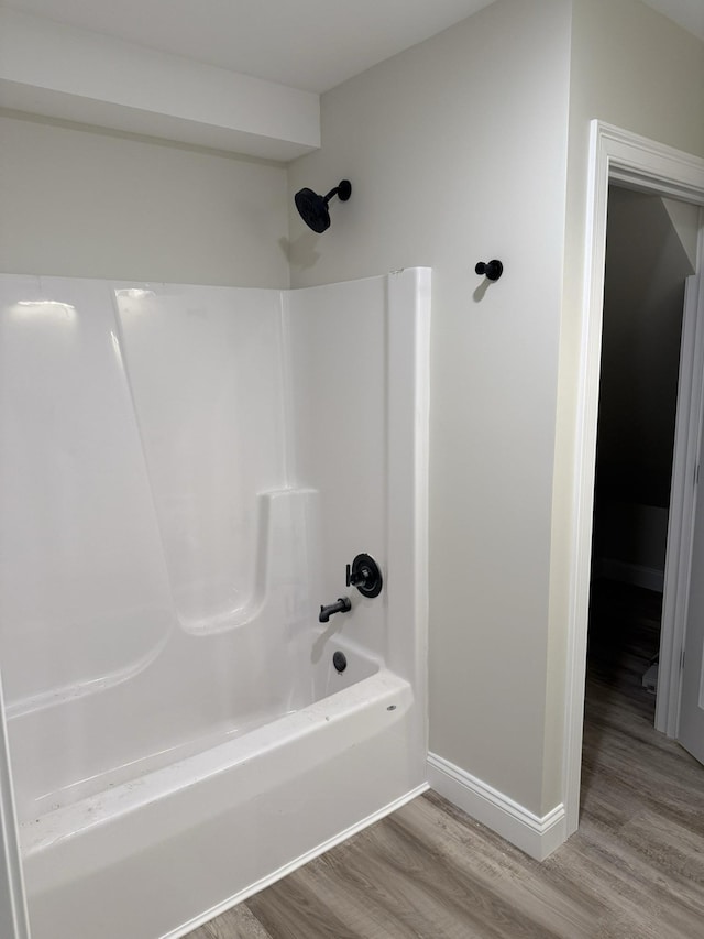 7 Willys Ln Unit 103, Milton, VT 05468 - full bath with wood finished floors, bathtub / shower combination, and baseboards