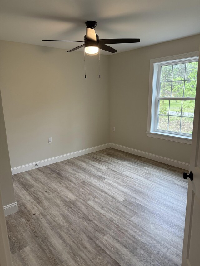 7 Willys Ln Unit 103, Milton, VT 05468 - empty room with a ceiling fan, wood finished floors, and baseboards