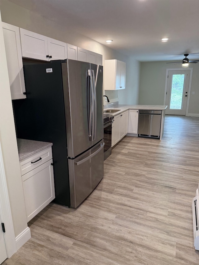 7 Willys Ln Unit 103, Milton, VT 05468 - kitchen with stainless steel appliances, light wood finished floors, white cabinets, light countertops, and recessed lighting