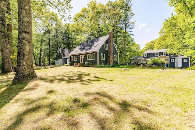 23 Cedarview Ln, Hampton, NH 03842 - view of front facade featuring a chimney and a front lawn