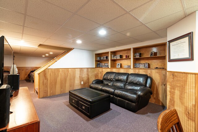 23 Cedarview Ln, Hampton, NH 03842 - carpeted living room with wooden walls, a wainscoted wall, a paneled ceiling, and built in features