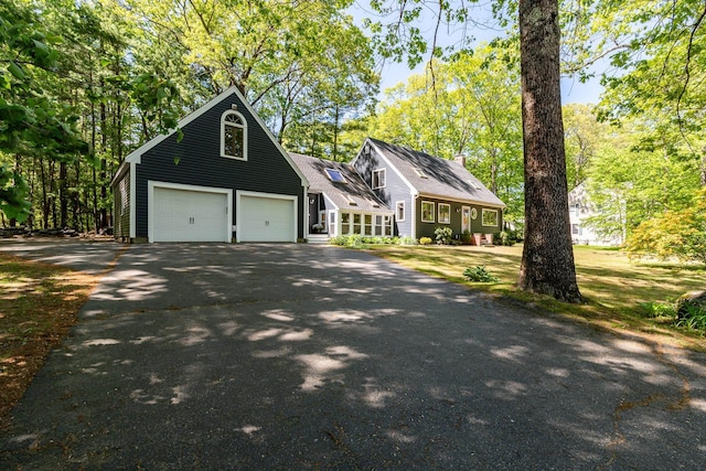 23 Cedarview Ln, Hampton, NH 03842 - view of front facade with asphalt driveway and a garage