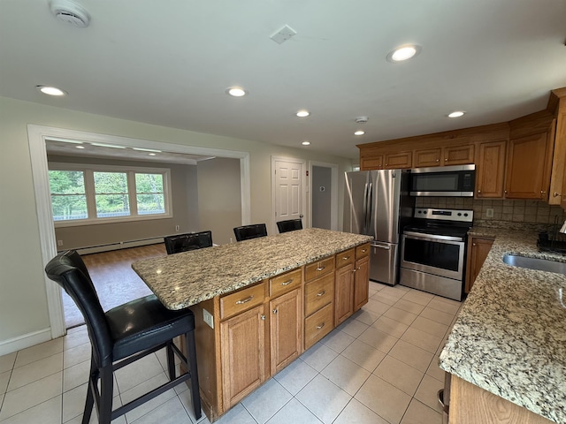 2 Germantown Rd, Derry, NH 03038 - kitchen with stainless steel appliances, a center island, recessed lighting, a sink, and a kitchen breakfast bar