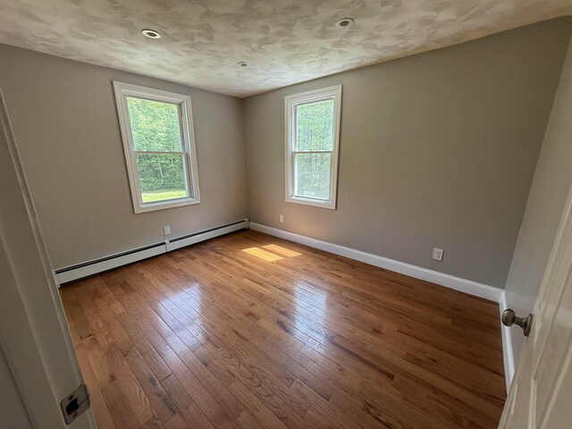 2 Germantown Rd, Derry, NH 03038 - unfurnished room with a baseboard radiator, plenty of natural light, and baseboards