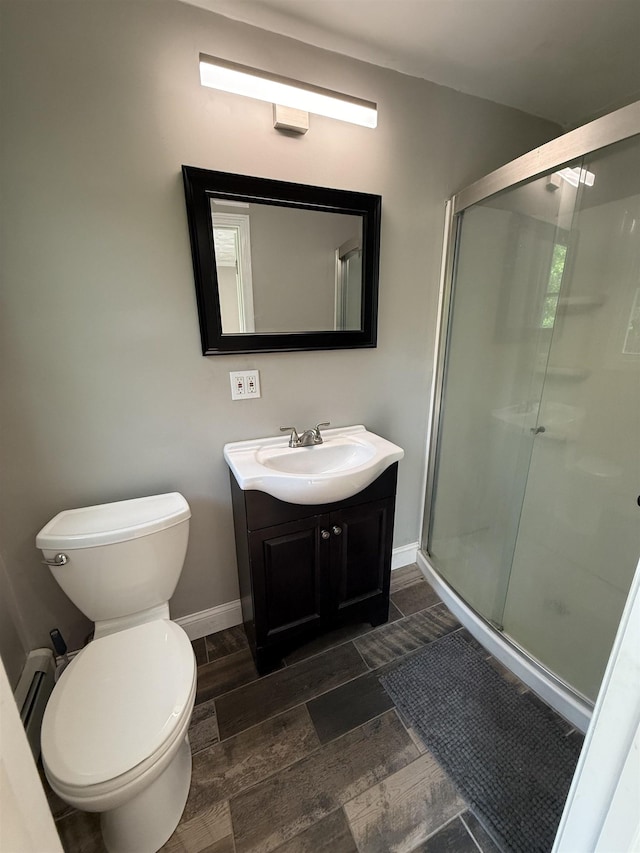 2 Germantown Rd, Derry, NH 03038 - bathroom with vanity, a stall shower, toilet, baseboards, and wood finished floors