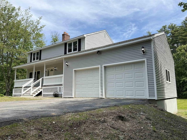2 Germantown Rd, Derry, NH 03038 - view of home's exterior featuring asphalt driveway, covered porch, a chimney, and an attached garage