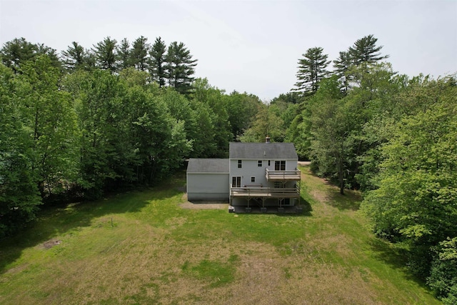 2 Germantown Rd, Derry, NH 03038 - back of property featuring a lawn, a wooden deck, a wooded view, driveway, and a chimney
