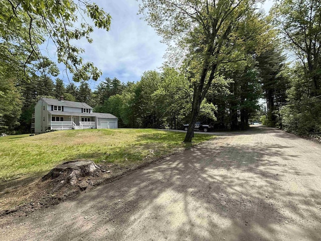 2 Germantown Rd, Derry, NH 03038 - view of green lawn with a detached garage and a wooded view