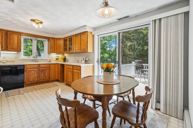 24 Theresa Ave, Salem, NH 03079 - kitchen with black dishwasher, a baseboard radiator, light countertops, and brown cabinetry