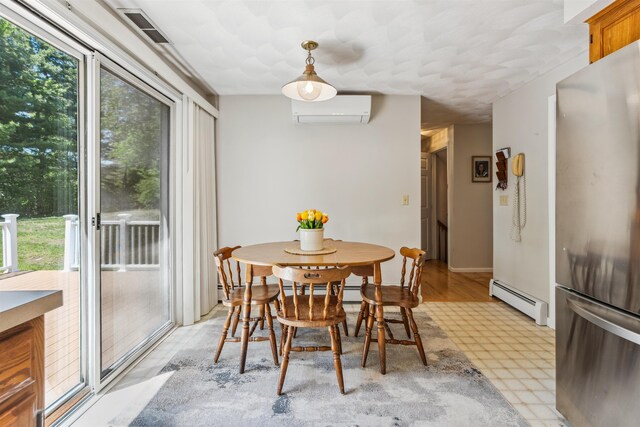 24 Theresa Ave, Salem, NH 03079 - dining space with baseboard heating, a wall unit AC, and light floors