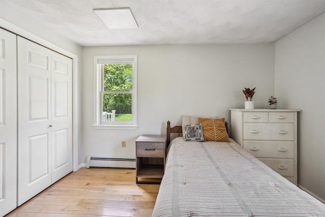 24 Theresa Ave, Salem, NH 03079 - bedroom featuring a baseboard heating unit, light wood finished floors, a closet, and baseboards