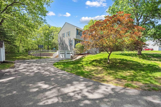 24 Theresa Ave, Salem, NH 03079 - view of front of house featuring a garage, asphalt driveway, and a front yard