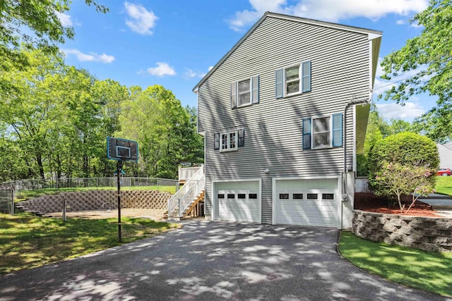24 Theresa Ave, Salem, NH 03079 - view of home's exterior featuring driveway, a garage, and stairway