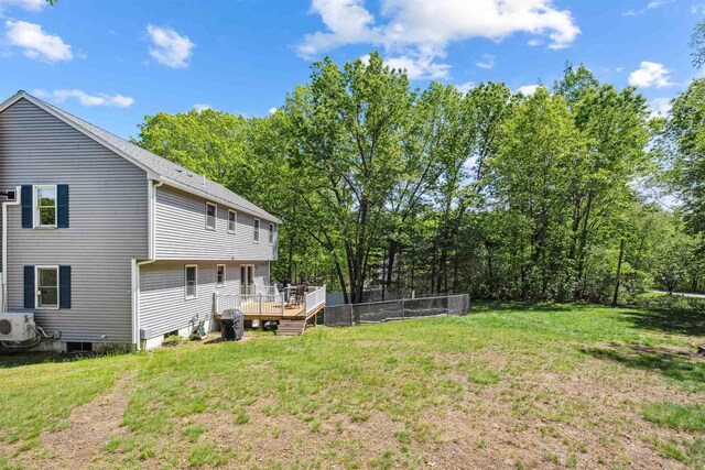 24 Theresa Ave, Salem, NH 03079 - view of grassy yard featuring a deck, ac unit, and view of wooded area