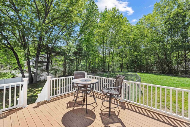 24 Theresa Ave, Salem, NH 03079 - deck with a lawn, outdoor dining area, and view of wooded area