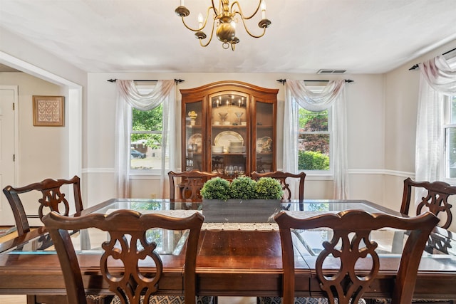 24 Theresa Ave, Salem, NH 03079 - dining area with healthy amount of natural light and a chandelier