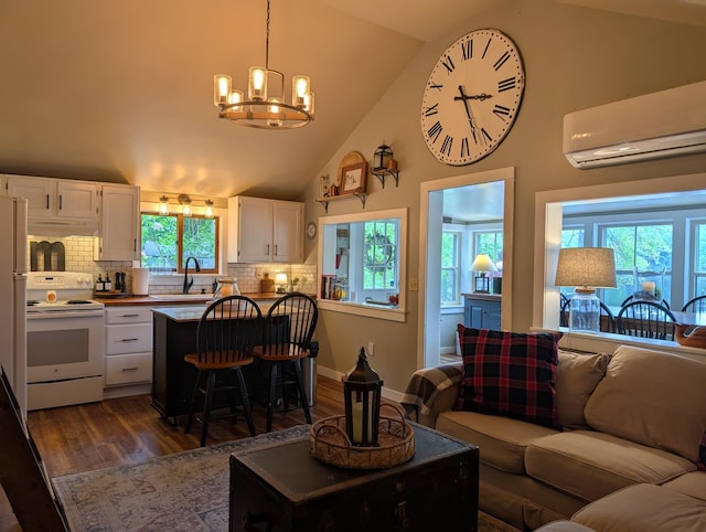 175 Rolfe Pond Dr, Hopkinton, NH 03229 - living room featuring dark wood-style floors, a wall mounted air conditioner, a chandelier, and high vaulted ceiling