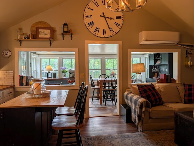175 Rolfe Pond Dr, Hopkinton, NH 03229 - dining room with a wall mounted air conditioner, lofted ceiling, dark wood-style flooring, and a chandelier