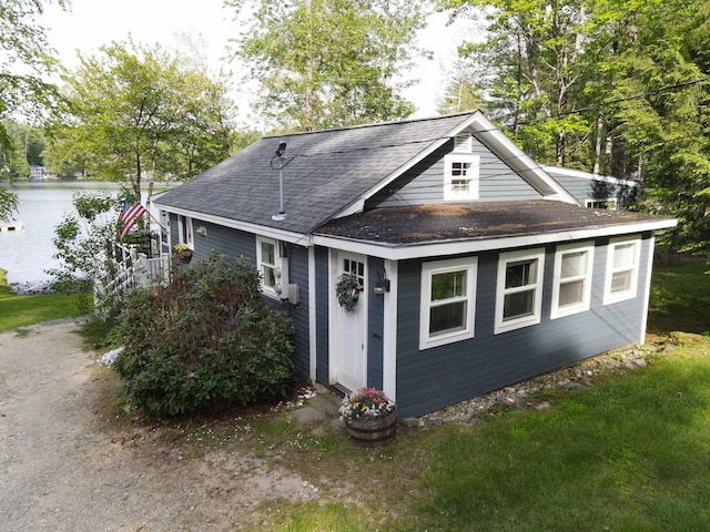 175 Rolfe Pond Dr, Hopkinton, NH 03229 - view of front facade featuring roof with shingles, a water view, and cooling unit