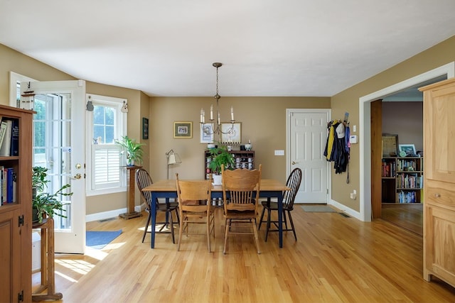 3 Playhouse Cir, Hampton, NH 03842 - dining space with light wood-type flooring, baseboards, and a chandelier