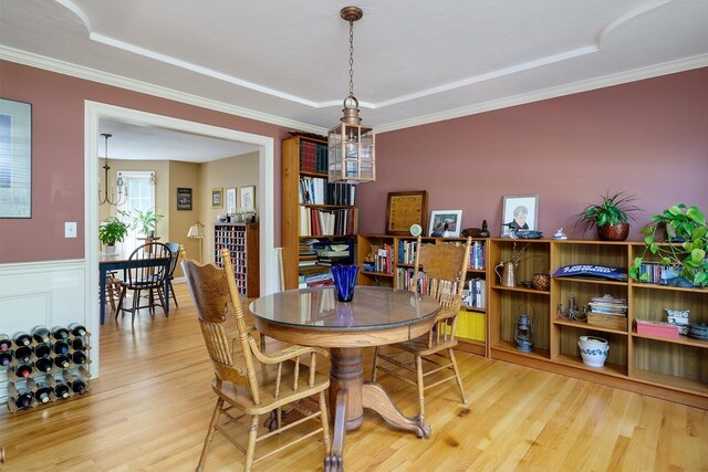3 Playhouse Cir, Hampton, NH 03842 - dining space featuring wood finished floors, a raised ceiling, and ornamental molding