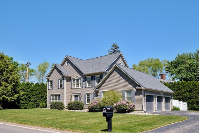 3 Playhouse Cir, Hampton, NH 03842 - colonial inspired home featuring asphalt driveway, a chimney, and an attached garage