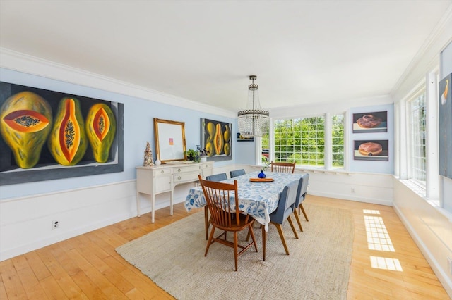 236 Main St, Jaffrey, NH 03452 - dining space featuring a chandelier, wood-type flooring, crown molding, and wainscoting