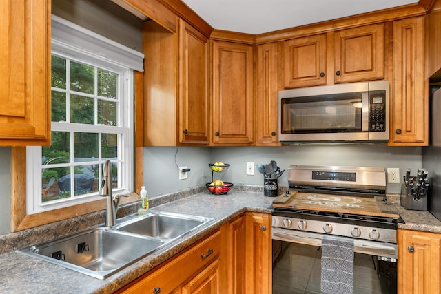 6 Cherry St, Concord, NH 03301 - kitchen featuring appliances with stainless steel finishes, a sink, brown cabinetry, and tile patterned flooring