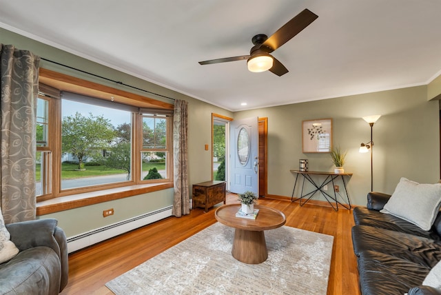 6 Cherry St, Concord, NH 03301 - living area featuring baseboard heating, crown molding, ceiling fan, wood finished floors, and baseboards