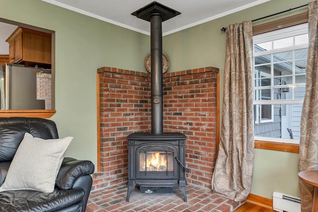 6 Cherry St, Concord, NH 03301 - detailed view of a baseboard radiator, a wood stove, ornamental molding, freestanding refrigerator, and baseboards