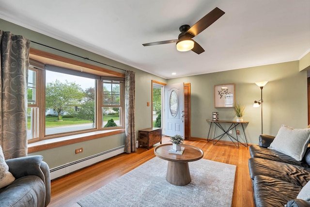 6 Cherry St, Concord, NH 03301 - living area with a baseboard heating unit, a ceiling fan, wood finished floors, crown molding, and baseboards
