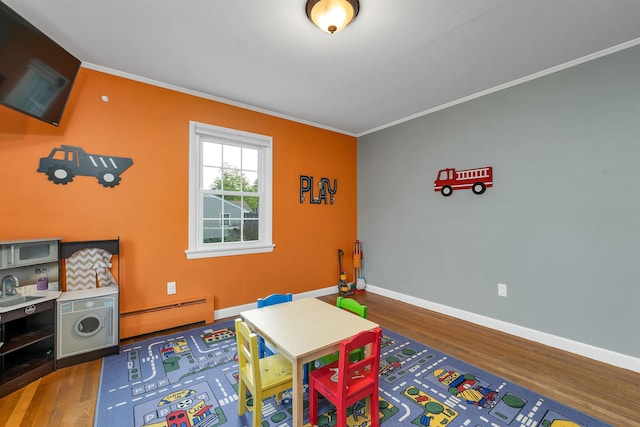 6 Cherry St, Concord, NH 03301 - rec room featuring a baseboard radiator, wood finished floors, crown molding, and baseboards